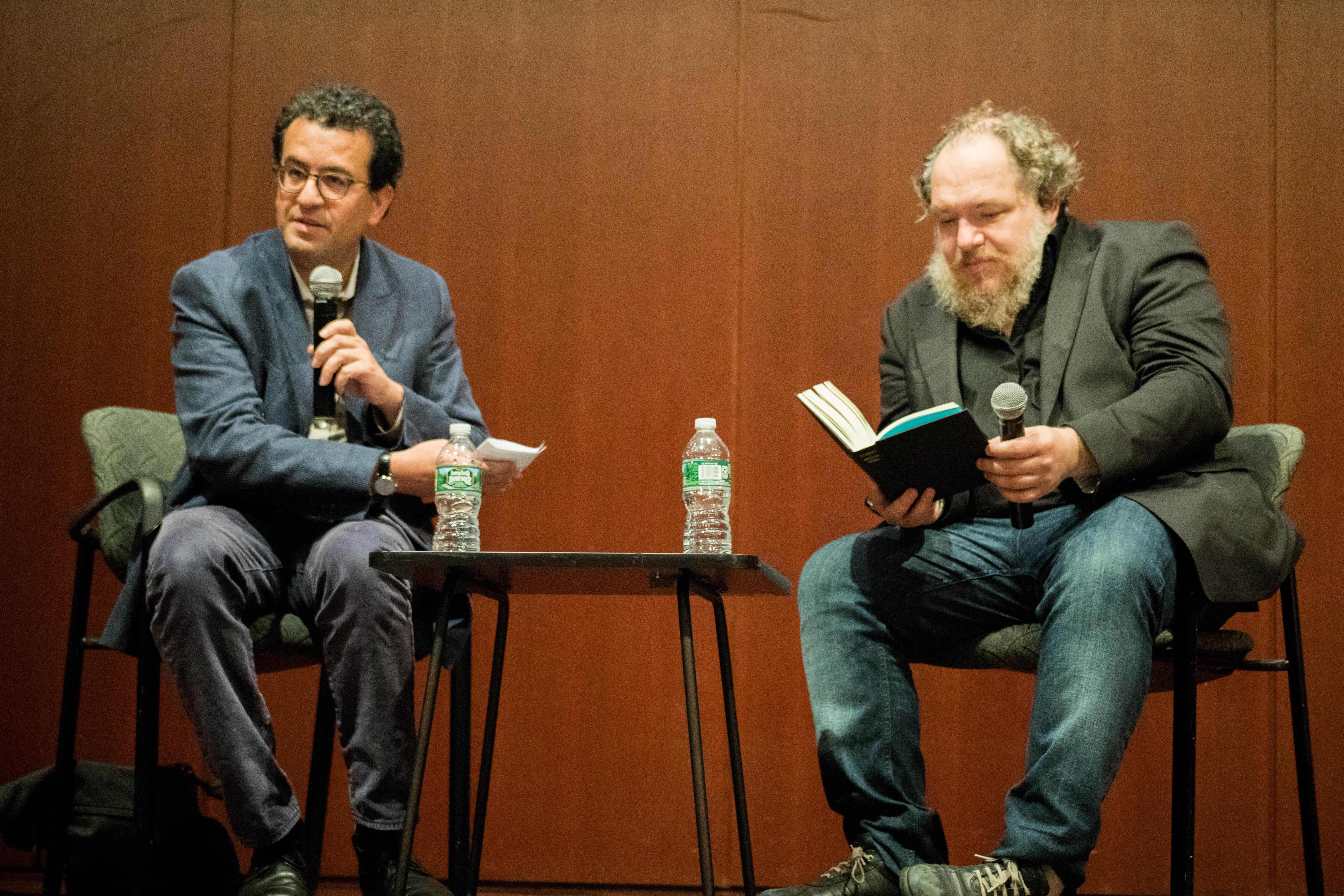 马赛厄斯恩纳德 and Hisham Matar sitting next to each other on a stage